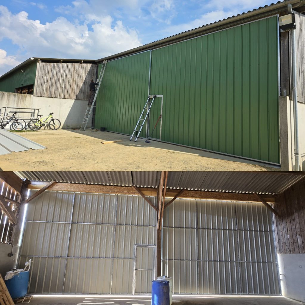 Grandes portes coulissantes métalliques sur mesure pour bâtiment agricole, avec bardage vert extérieur et structure métallique intérieure.